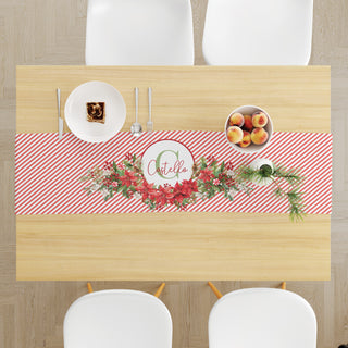 Table runner with a poinsettia and stripes pattern, personalized with a name and initial for a festive and elegant touch.