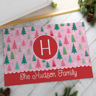 Thin doormat featuring a whimsical pink pine forest design, personalized with a name at the bottom and initial in the center