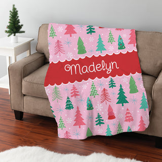 Fuzzy blanket featuring a whimsical pink pine forest design, personalized with a name in the center.