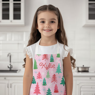 Youth apron featuring a whimsical pink pine forest design, personalized with a name for a fun and custom touch