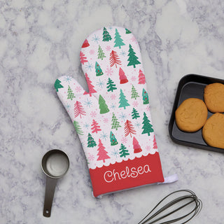 Oven mitt featuring a pine forest design, personalized with a name by the wrist for a festive and custom touch. 