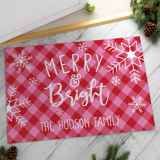 Thin doormat featuring a "Merry & Bright" message with a pink and red check pattern, personalized for a festive touch.