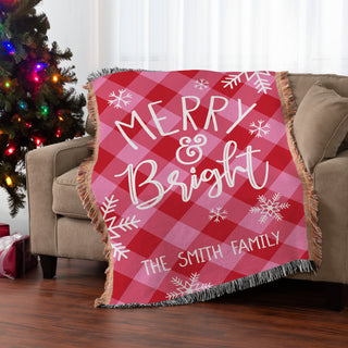 Fringe throw blanket featuring a "Merry & Bright" message with a pink and red check pattern, personalized with a name.