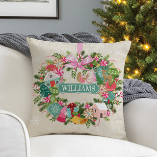 17" throw pillow featuring a whimsical ornament wreath design, personalized with a name in the center.