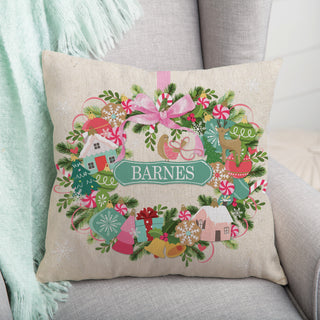 14" throw pillow featuring a whimsical ornament wreath design, personalized with a name in the center.